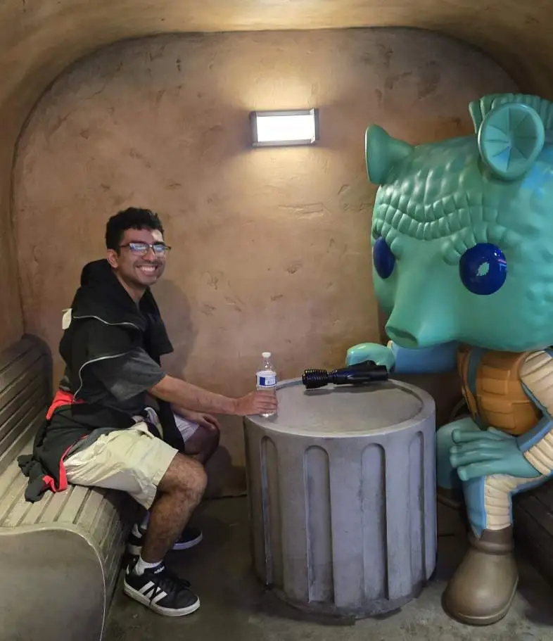 Adrian Gonzalez at Disneyland next to a Star Wars statue