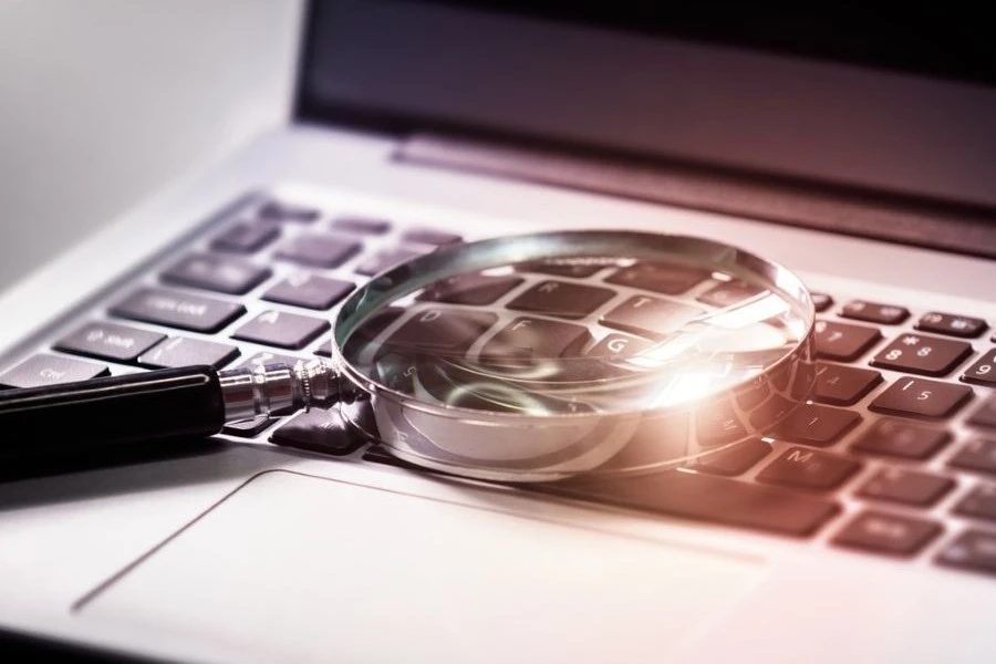 Magnifying glass on a computer representing SEO